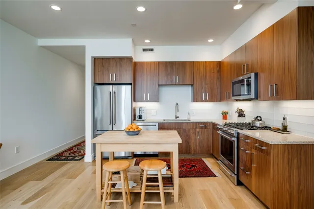 a kitchen with a sink stove and refrigerator