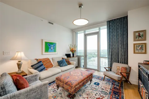 a living room with furniture and a lamp