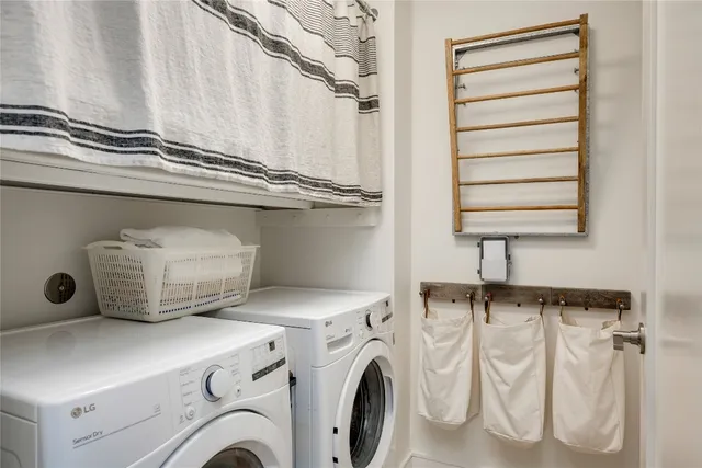 a bathroom with a double vanity sink toilet mirror and shower