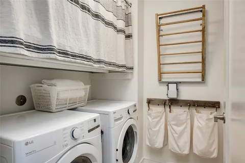 a bathroom with a double vanity sink toilet mirror and shower