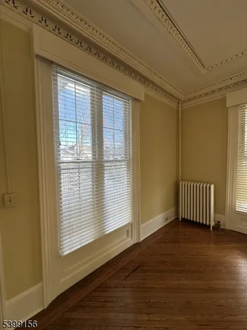 wooden floor in an empty room with a fireplace