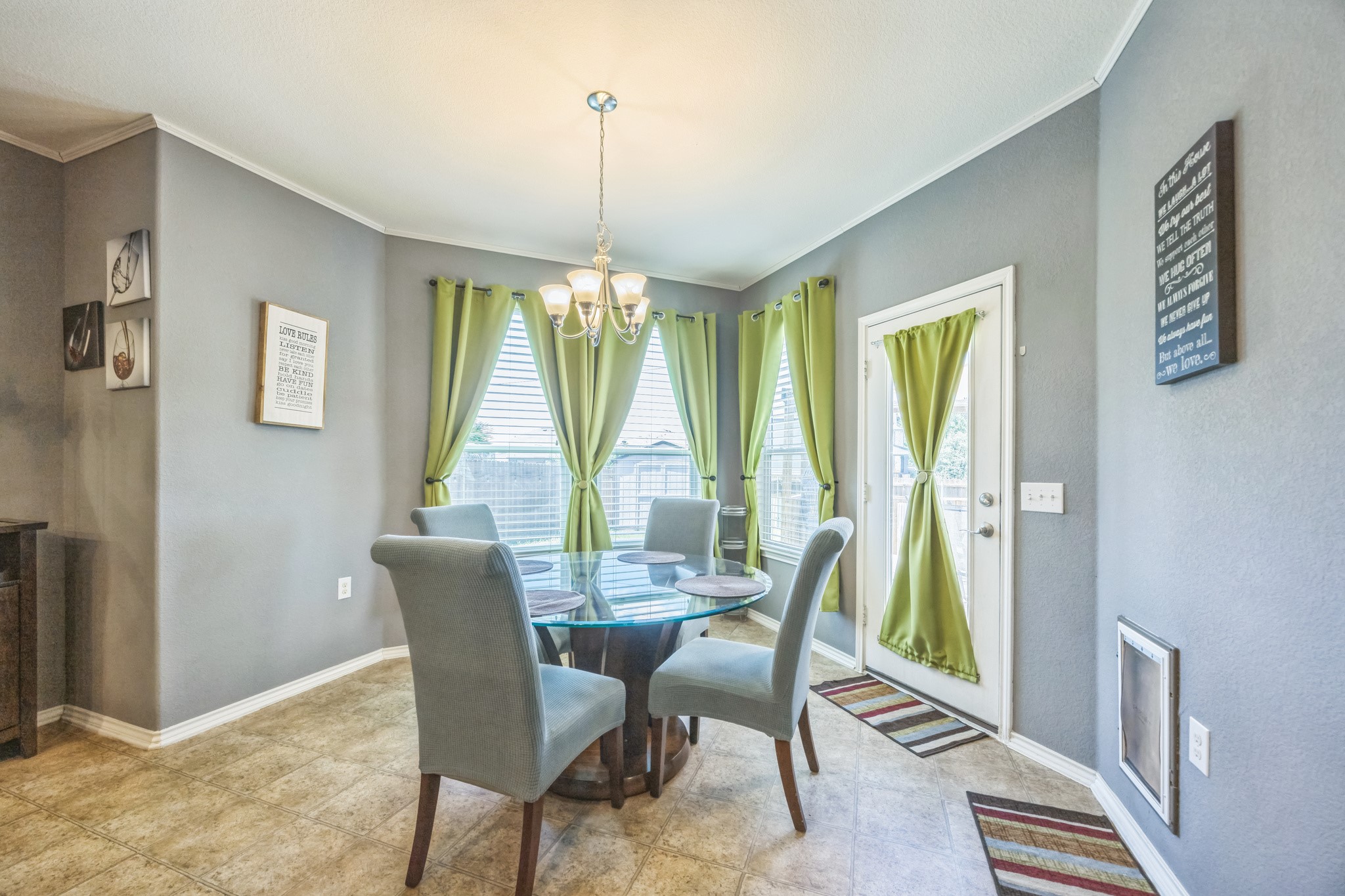 6401 Quinton Drive Austin, TX 78747 - Photo 13 of 29 a dining room with furniture a chandelier and wooden floor