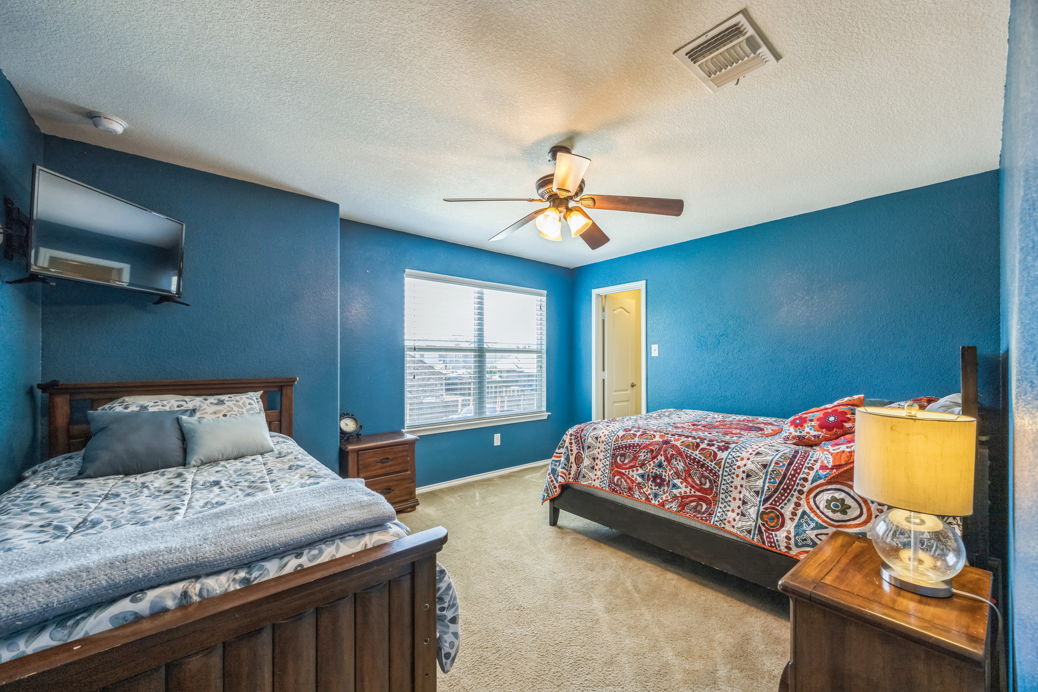 6401 Quinton Drive Austin, TX 78747 - Photo 23 of 29 a bedroom with a bed and a chandelier