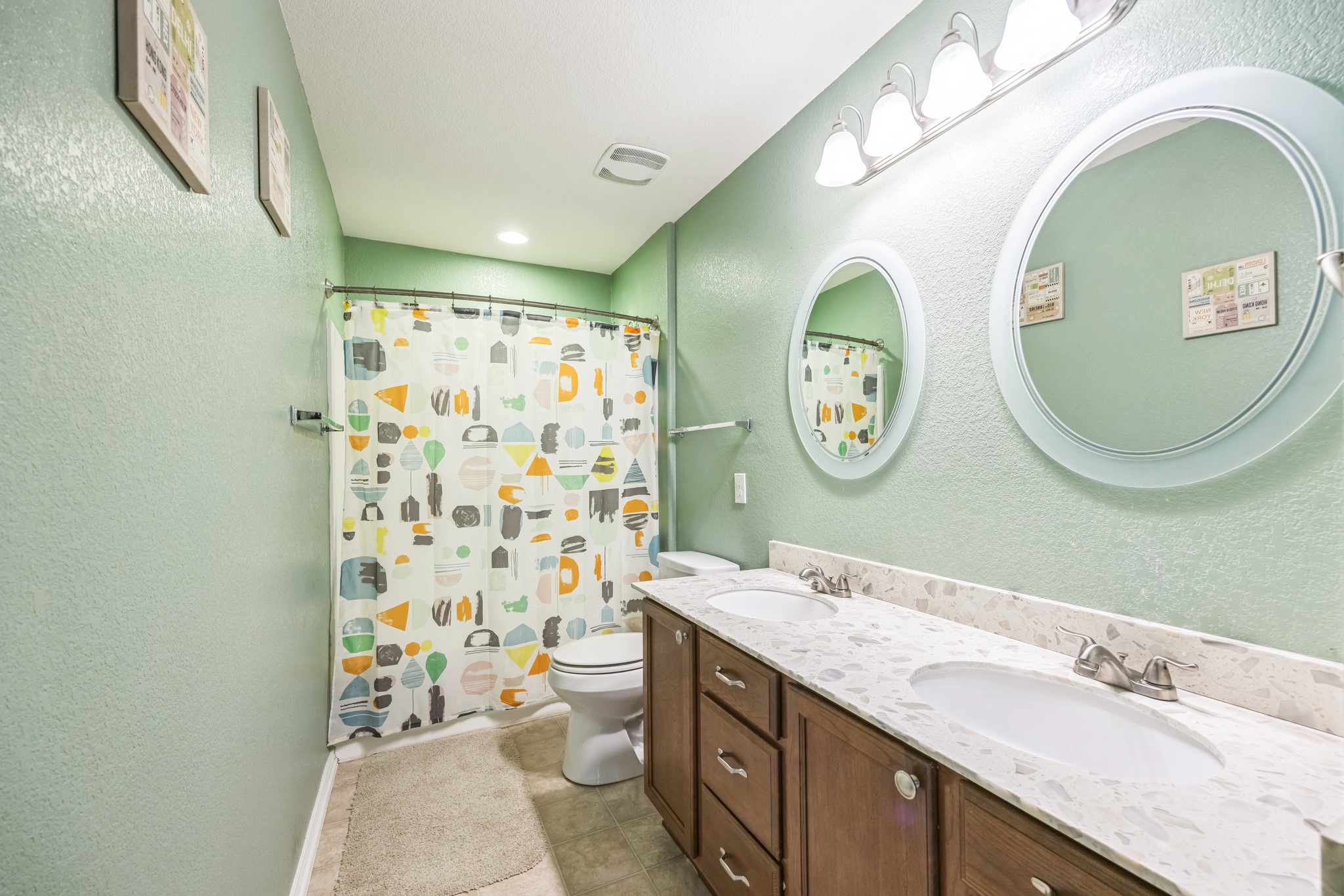 6401 Quinton Drive Austin, TX 78747 - Photo 24 of 29 a bathroom with a granite countertop toilet a sink and a mirror
