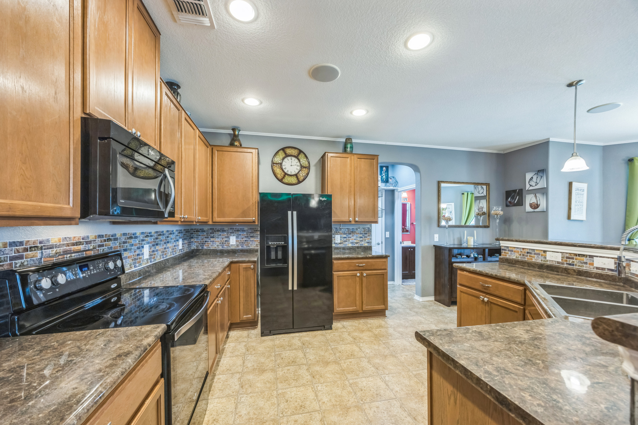 6401 Quinton Drive Austin, TX 78747 - Photo 10 of 29 a kitchen with stainless steel appliances granite countertop a sink stove and refrigerator