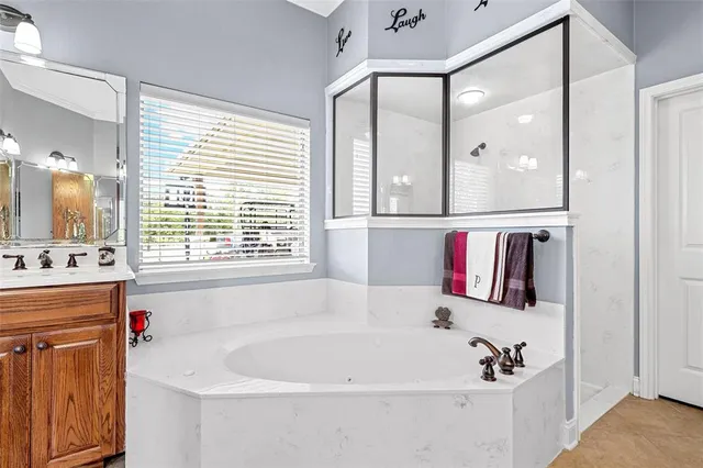 a white bath tub sitting next to a bathroom sink
