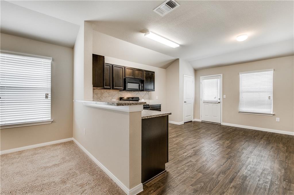 185 Voss Kyle, TX 78640 - Photo 4 of 26 a view of workspace with wooden floor windows and fireplace