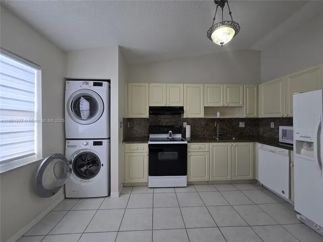 a kitchen with a stove top oven and cabinets