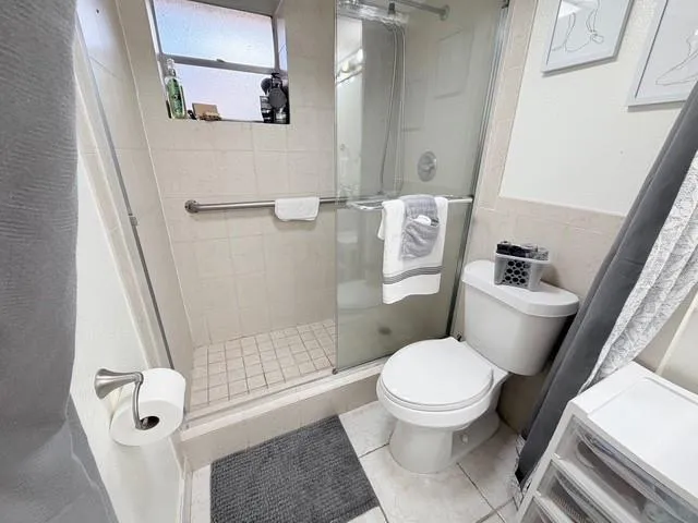 a white toilet sitting next to a bath tub