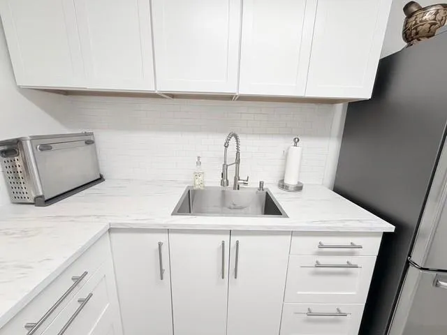 a kitchen with white cabinets