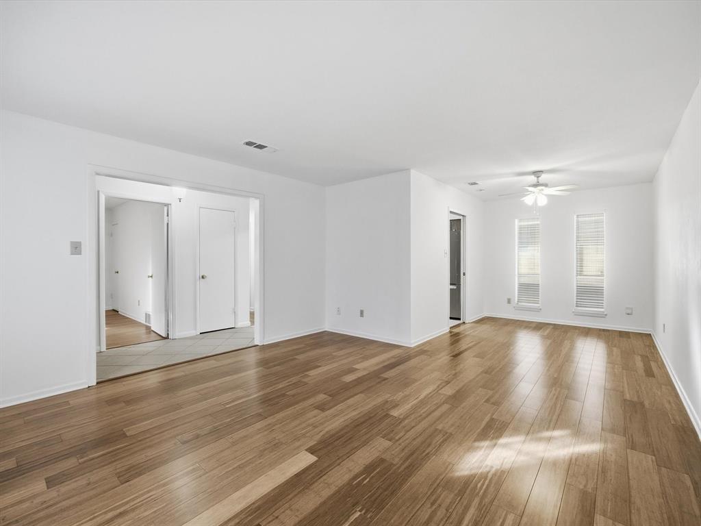 4613 Ranch View Road Fort Worth, TX 76109 - Photo 12 of 24 a view of an empty room with wooden floor and window