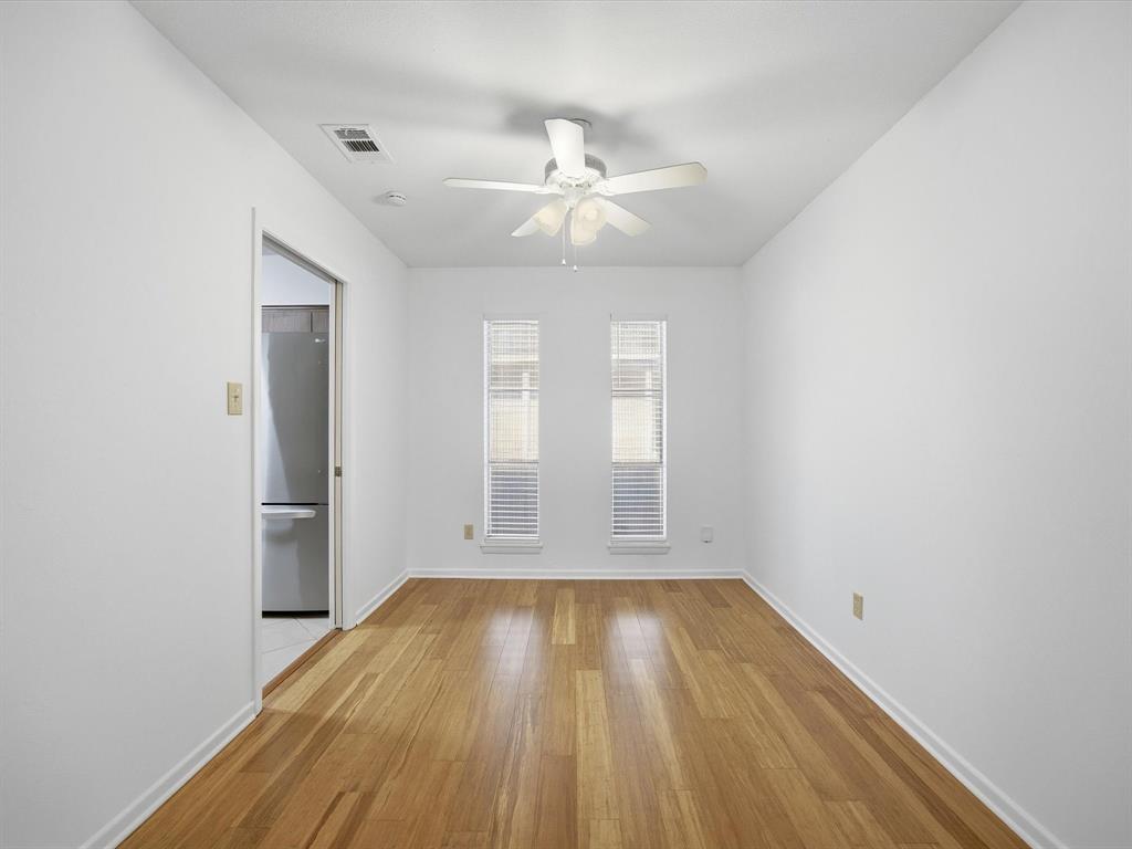 4613 Ranch View Road Fort Worth, TX 76109 - Photo 13 of 24 an empty room with wooden floor fan and windows