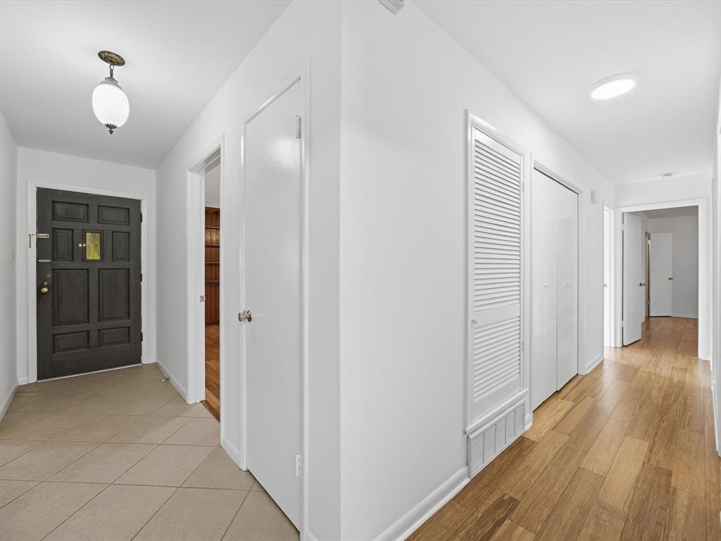 4613 Ranch View Road Fort Worth, TX 76109 - Photo 16 of 24 a view of a hallway with wooden floor and a chandelier
