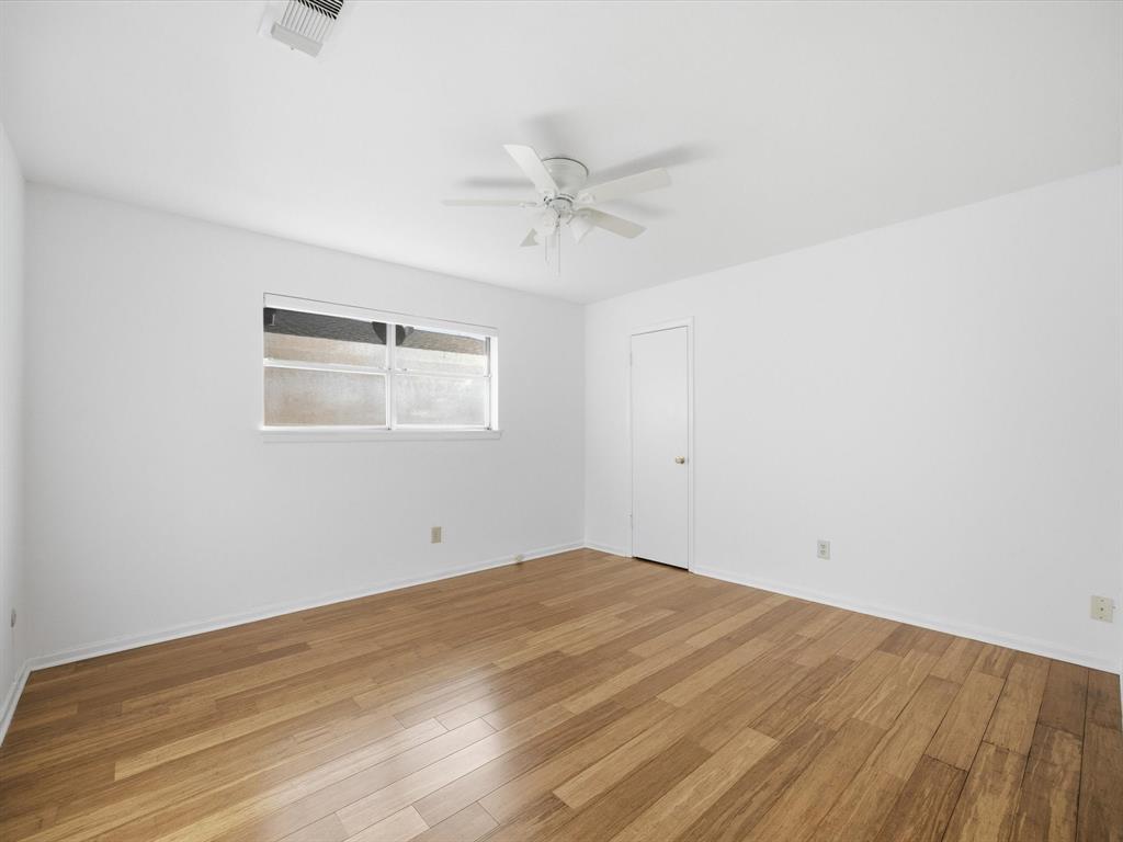 4613 Ranch View Road Fort Worth, TX 76109 - Photo 17 of 24 an empty room with wooden floor and windows