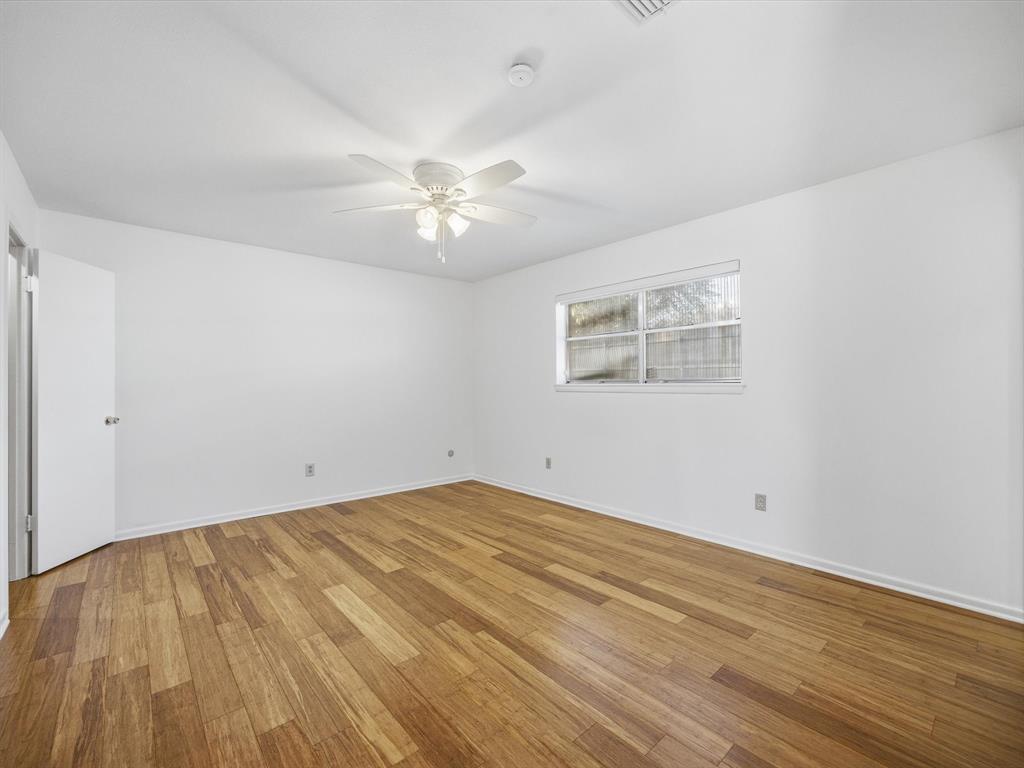 4613 Ranch View Road Fort Worth, TX 76109 - Photo 19 of 24 a view of empty room with wooden floor and fan