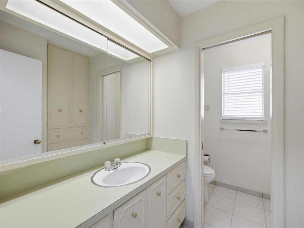 4613 Ranch View Road Fort Worth, TX 76109 - Photo 23 of 24 a bathroom with a granite countertop sink and a mirror