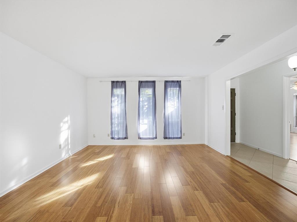 4613 Ranch View Road Fort Worth, TX 76109 - Photo 7 of 24 a view of an empty room with wooden floor and a window