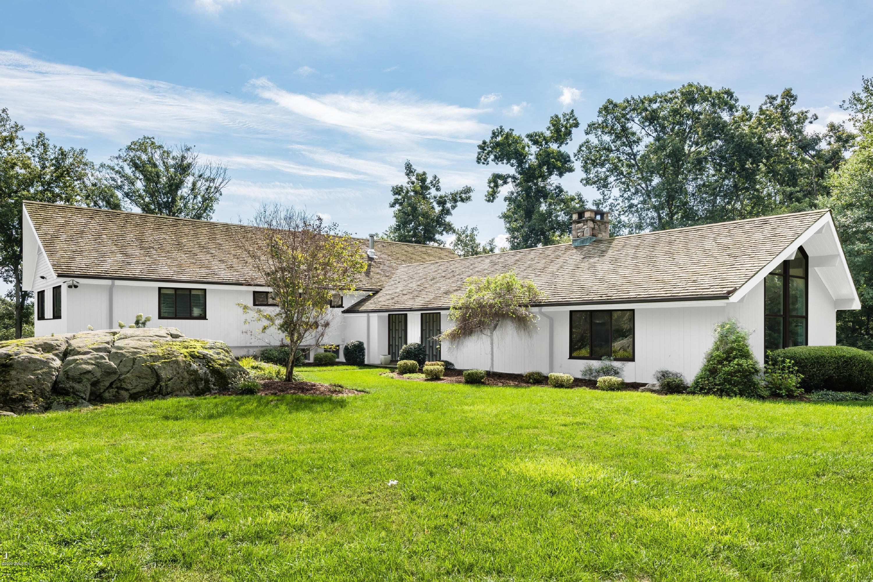 84 Burning Tree Road Greenwich, CT 06830 - Photo 1 of 28 a front view of house with yard and green space