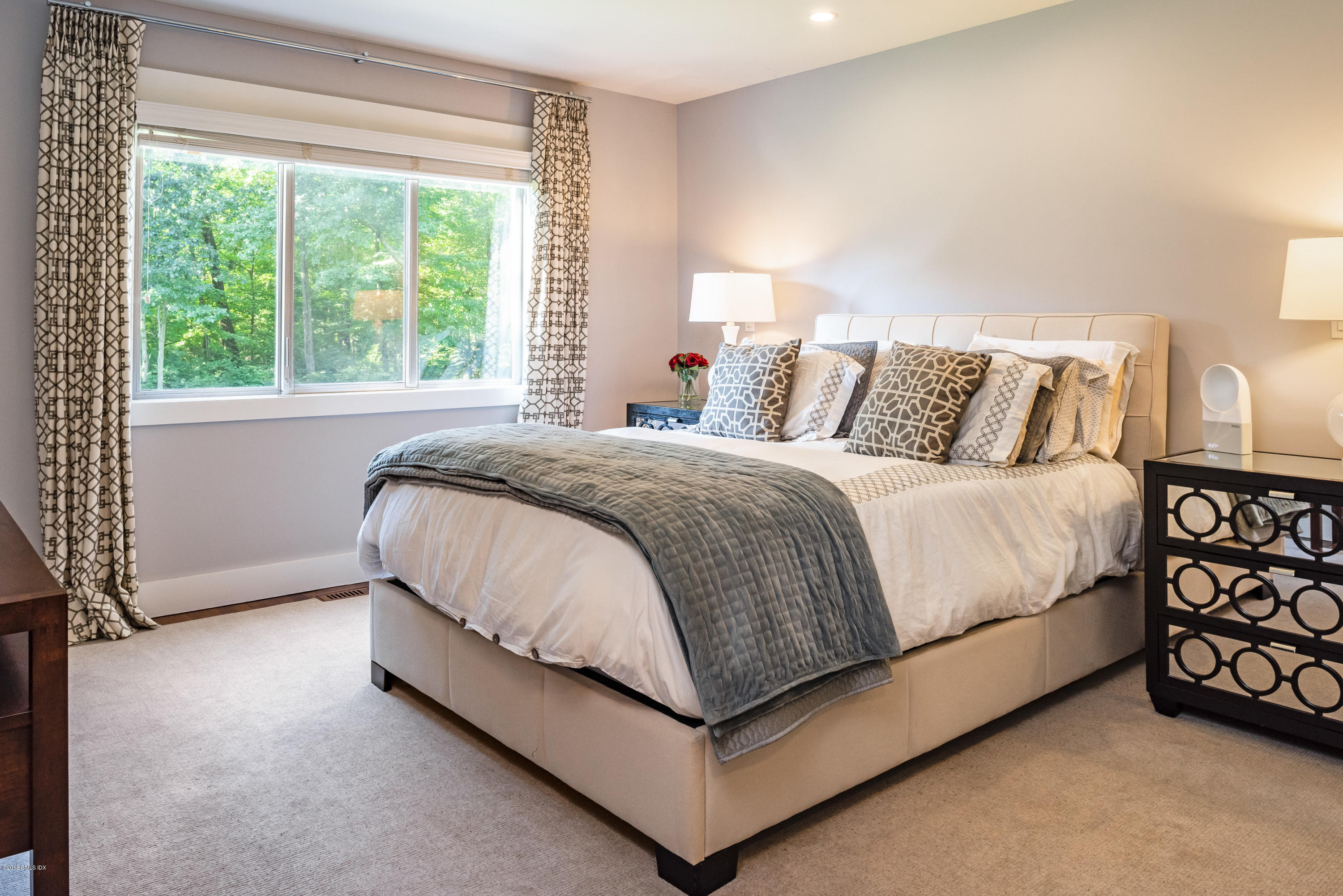 84 Burning Tree Road Greenwich, CT 06830 - Photo 14 of 28 a bed sitting in a bedroom next to a window