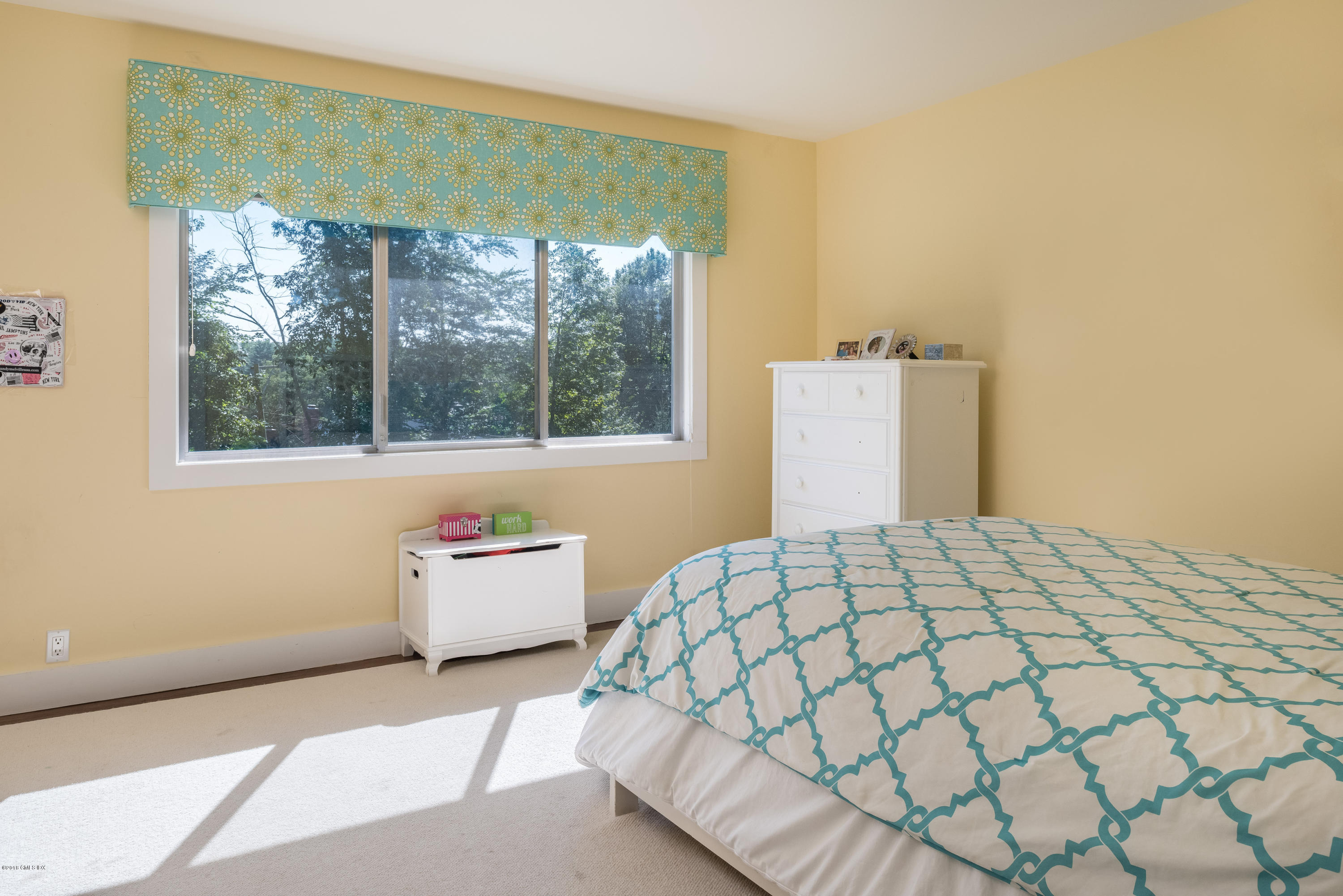 84 Burning Tree Road Greenwich, CT 06830 - Photo 17 of 28 a bedroom with a bed and window
