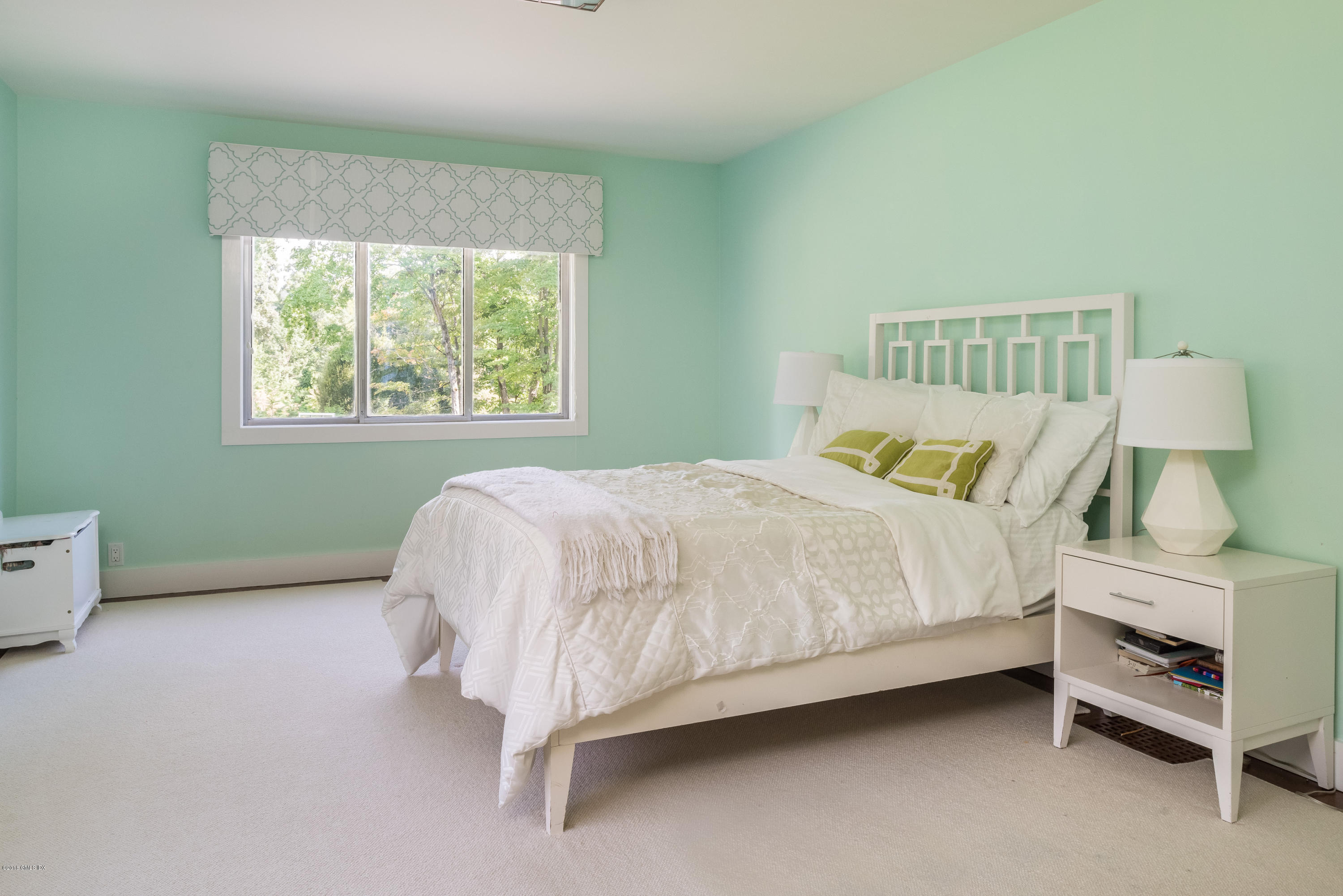 84 Burning Tree Road Greenwich, CT 06830 - Photo 18 of 28 a bedroom with a bed and a window