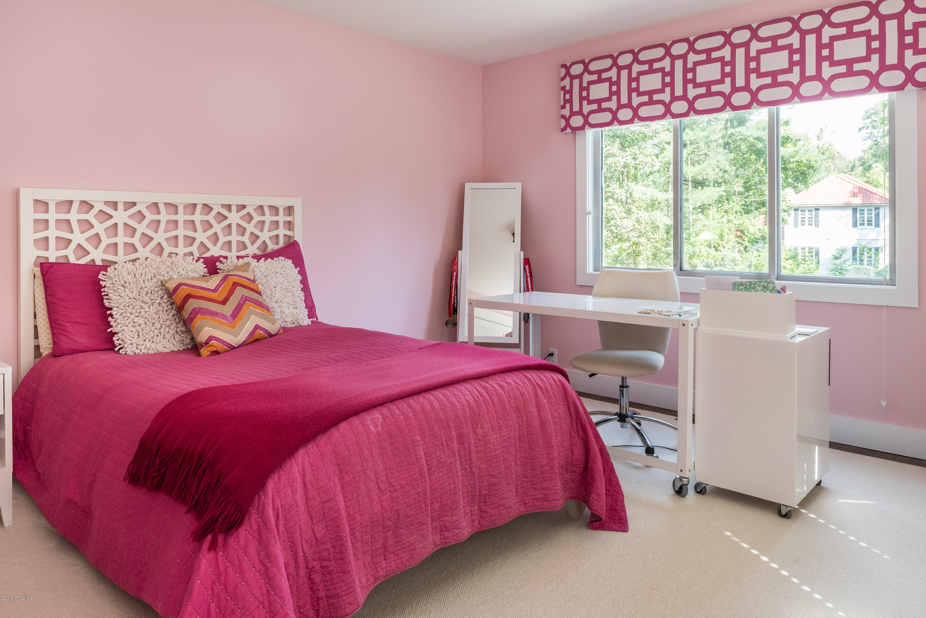 84 Burning Tree Road Greenwich, CT 06830 - Photo 20 of 28 a bedroom with a bed and a window