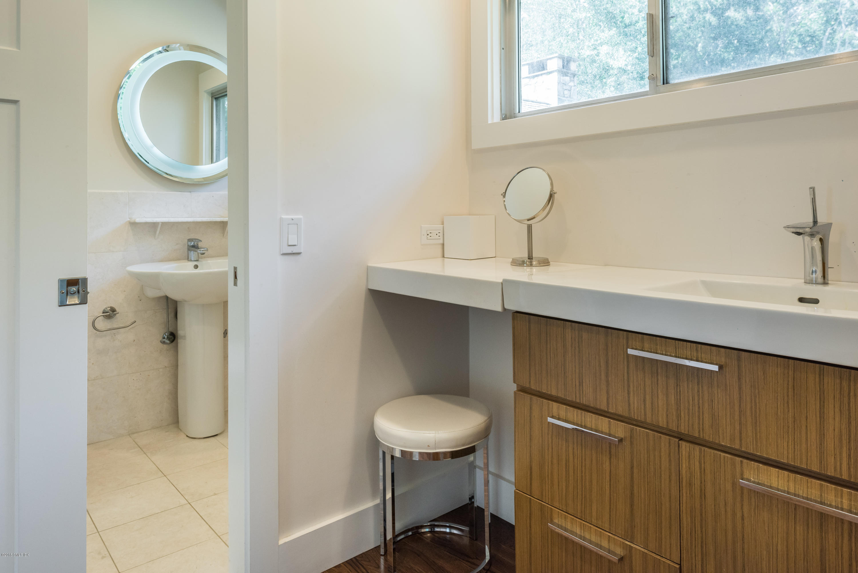 84 Burning Tree Road Greenwich, CT 06830 - Photo 21 of 28 a bathroom with a toilet sink a mirror and vanity