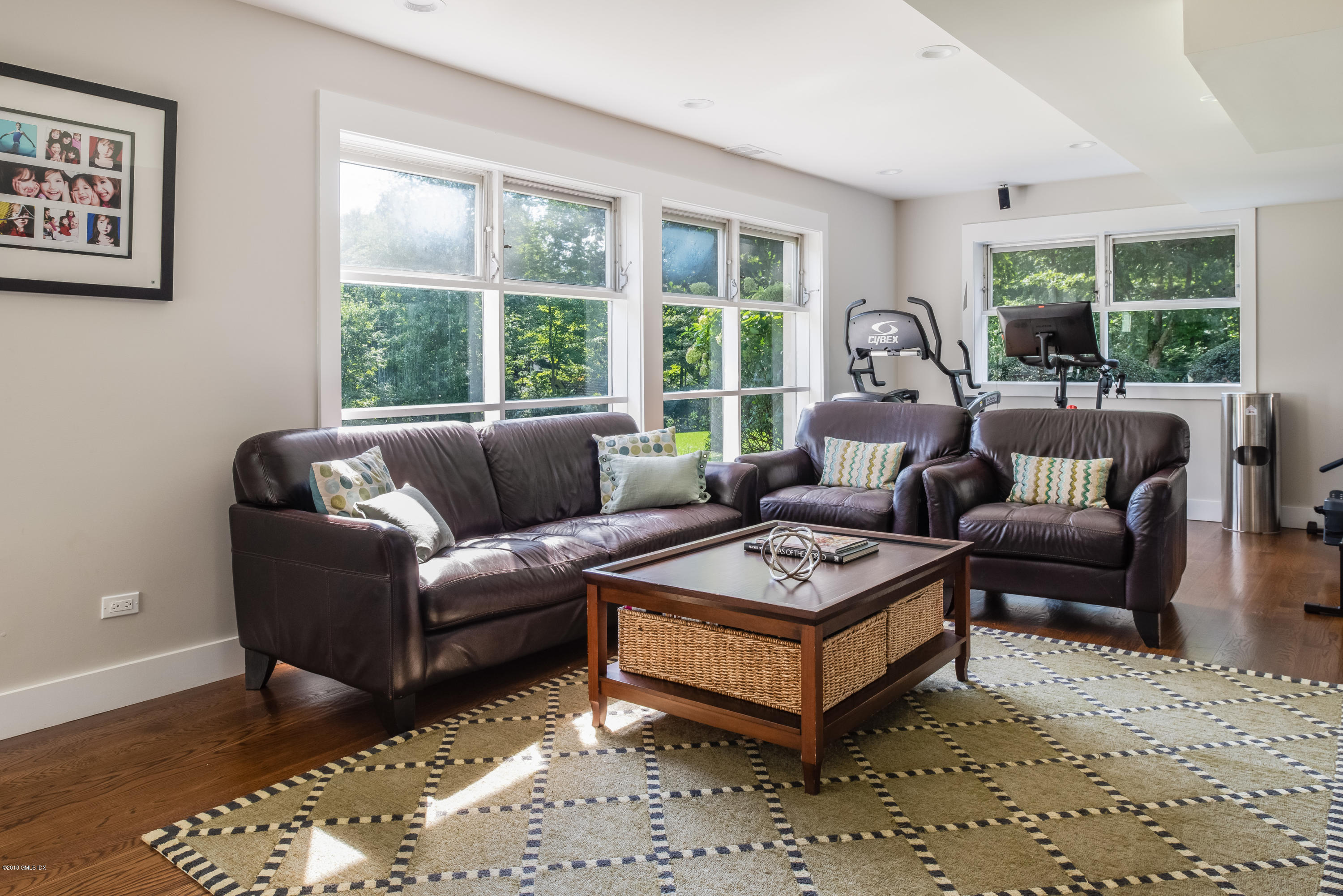 84 Burning Tree Road Greenwich, CT 06830 - Photo 22 of 28 a living room with furniture a large window and a table