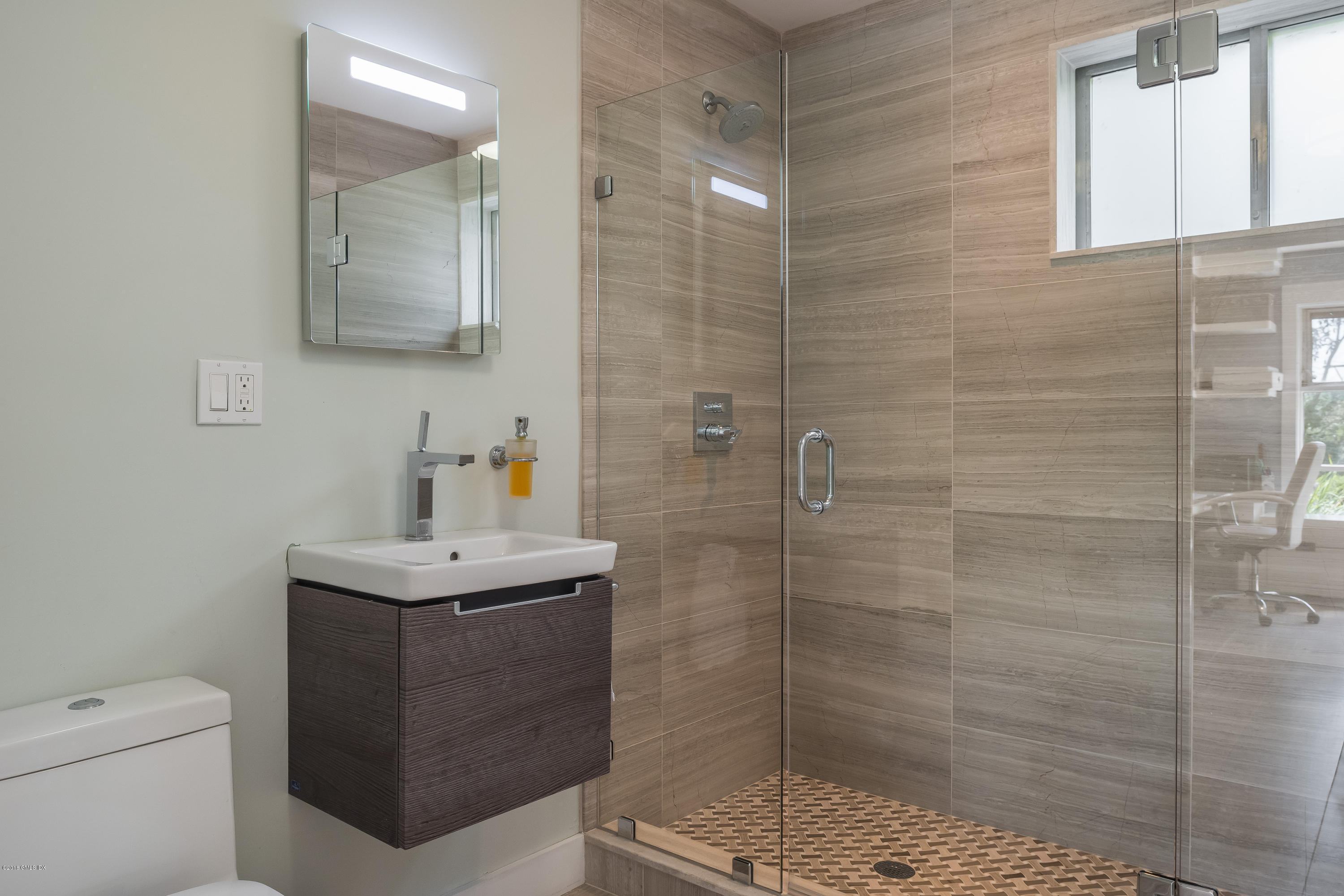 84 Burning Tree Road Greenwich, CT 06830 - Photo 24 of 28 a bathroom with a sink a toilet and shower