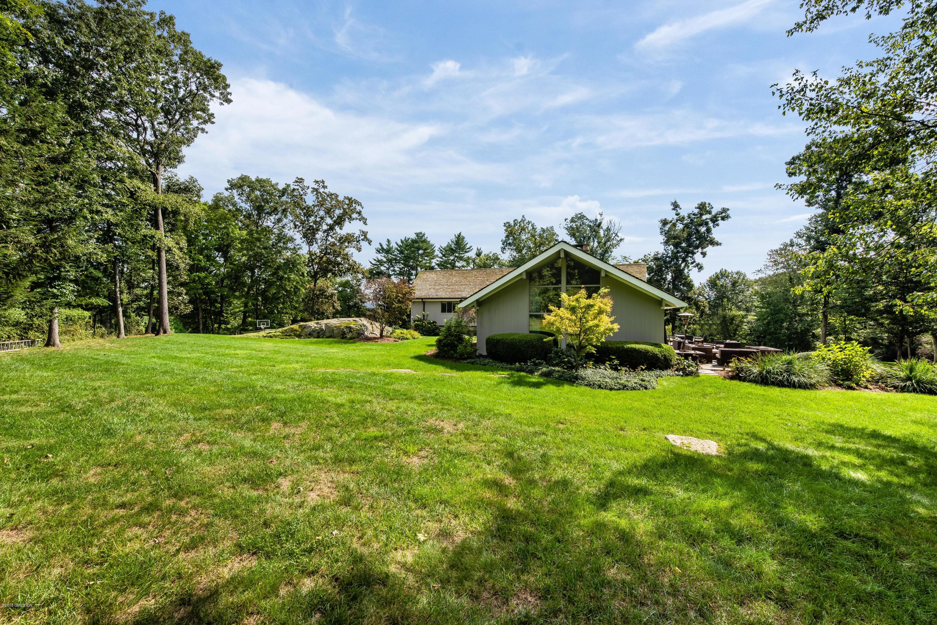 84 Burning Tree Road Greenwich, CT 06830 - Photo 25 of 28 a house view with a garden space