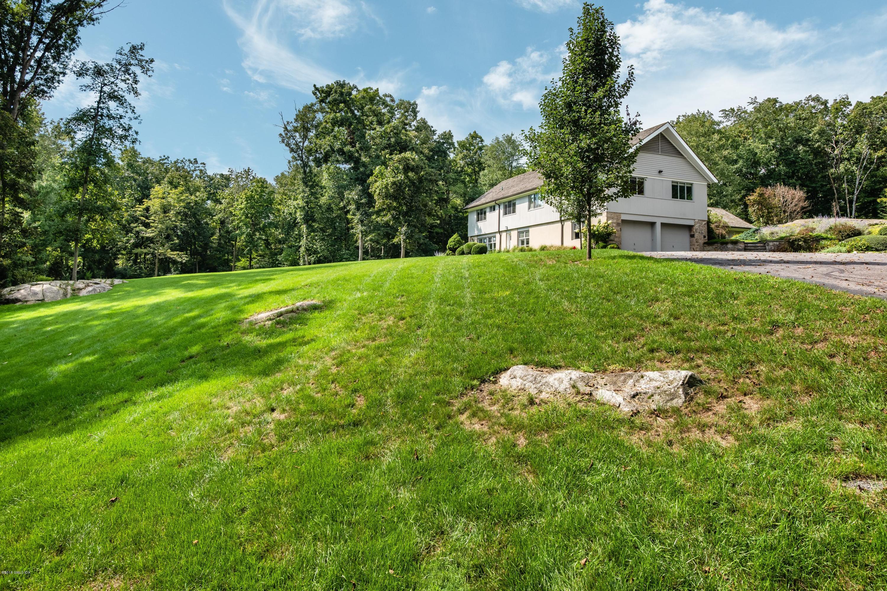 84 Burning Tree Road Greenwich, CT 06830 - Photo 4 of 28 a front view of a house with garden