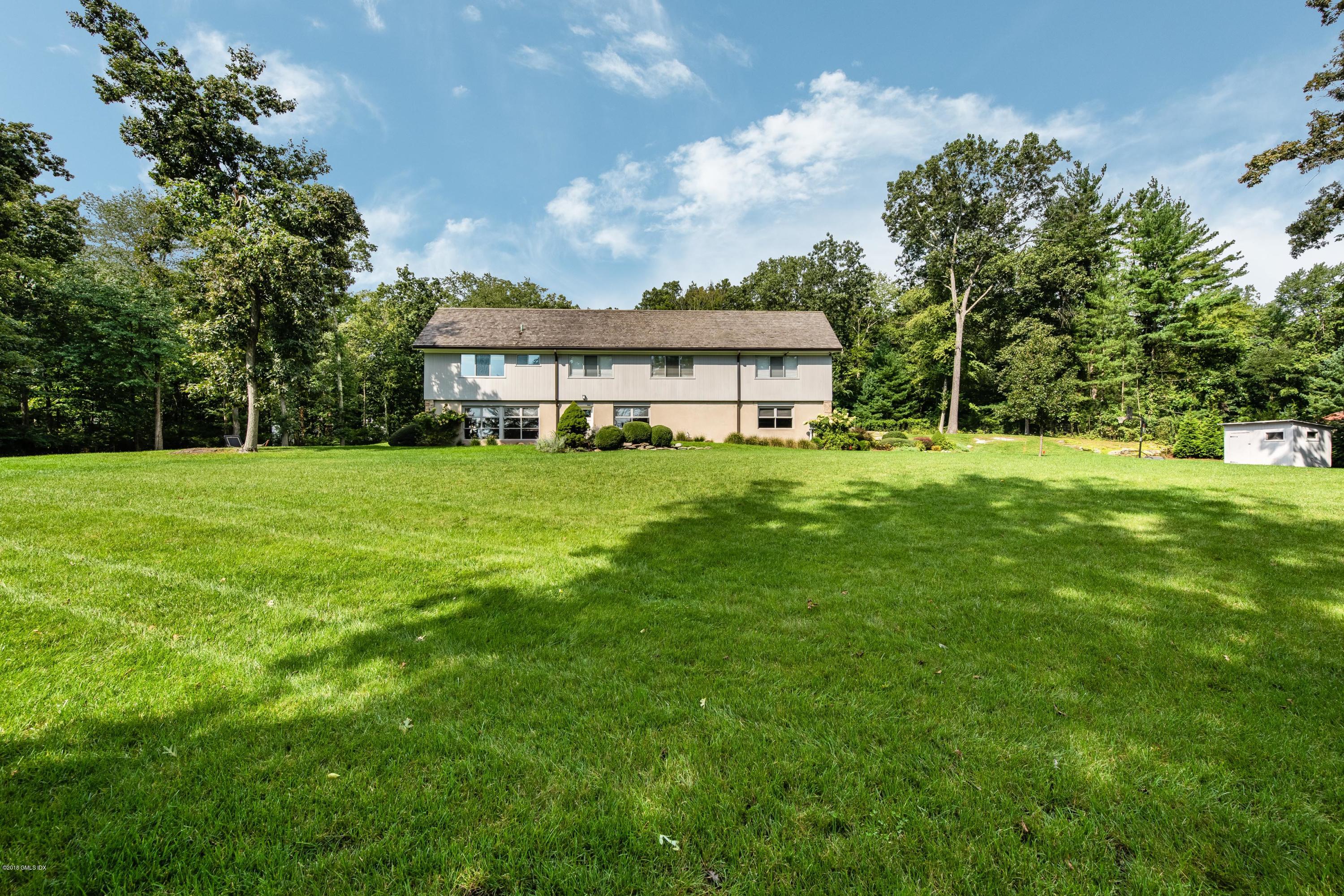 84 Burning Tree Road Greenwich, CT 06830 - Photo 6 of 28 a view of a house with a big yard