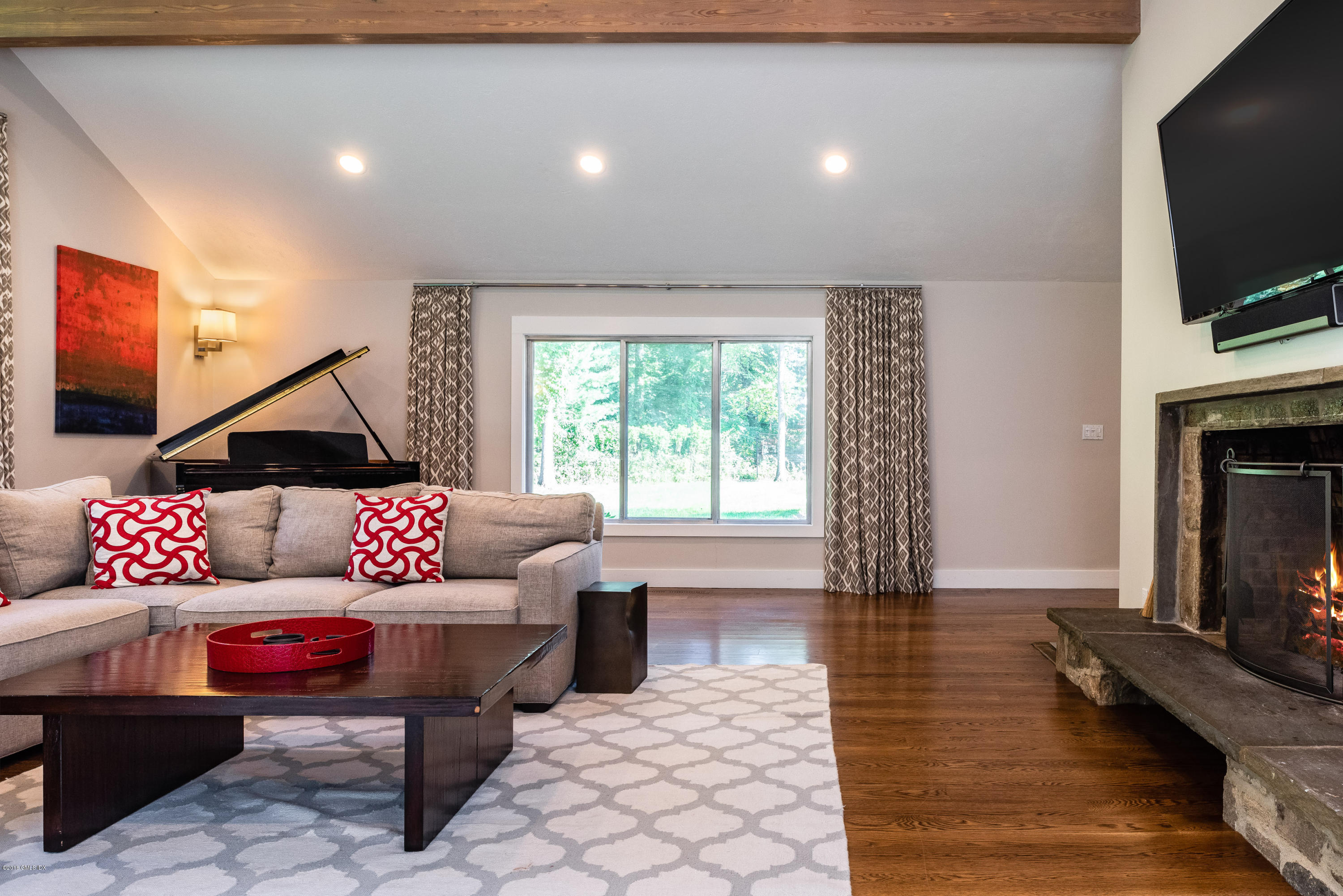 84 Burning Tree Road Greenwich, CT 06830 - Photo 9 of 28 a living room with furniture and a flat screen tv