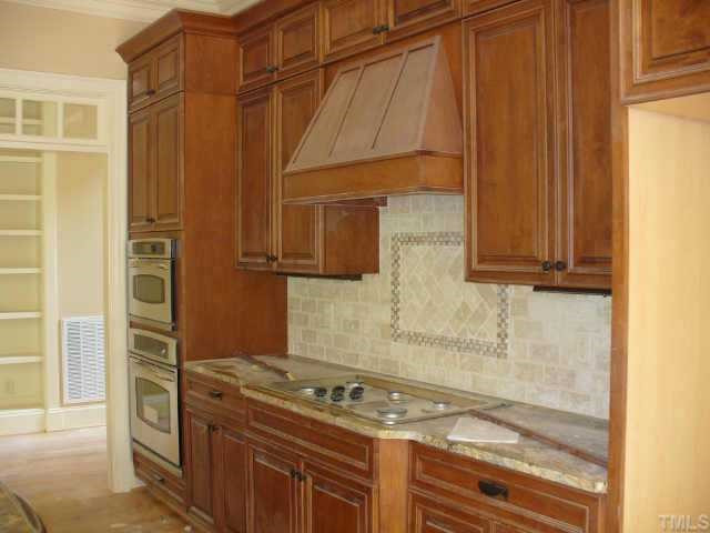 8636 Baybridge Raleigh, NC 27604 - Photo 2 of 10 a kitchen with a stove and a cabinet