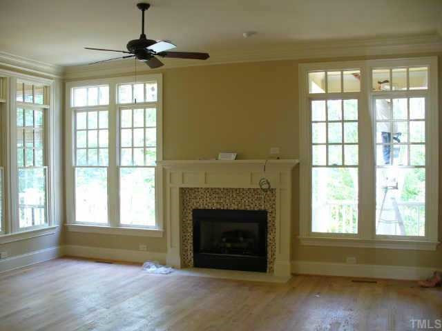 8636 Baybridge Raleigh, NC 27604 - Photo 3 of 10 a living room with a fireplace and a window