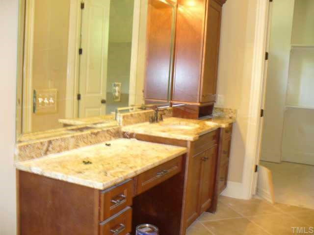 8636 Baybridge Raleigh, NC 27604 - Photo 5 of 10 a bathroom with a sink and a mirror