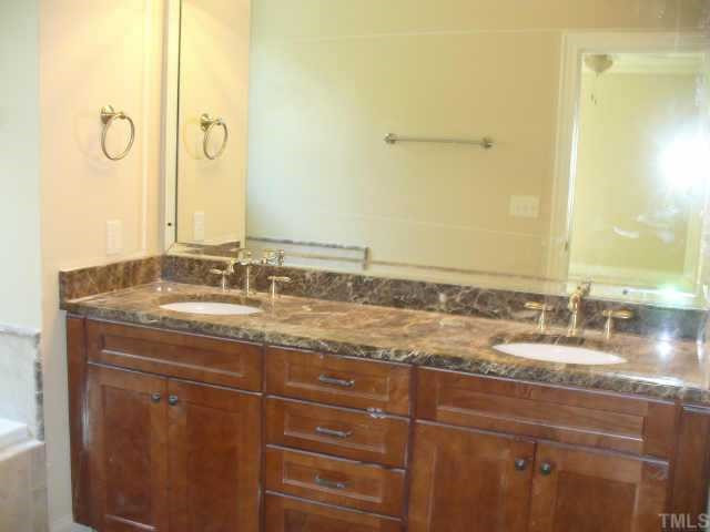 8636 Baybridge Raleigh, NC 27604 - Photo 6 of 10 a bathroom with a granite countertop sink and a mirror