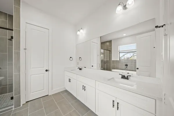 a bathroom with a double vanity sink mirror and