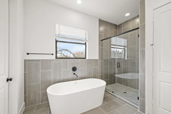 a white bath tub sitting next to a bathroom