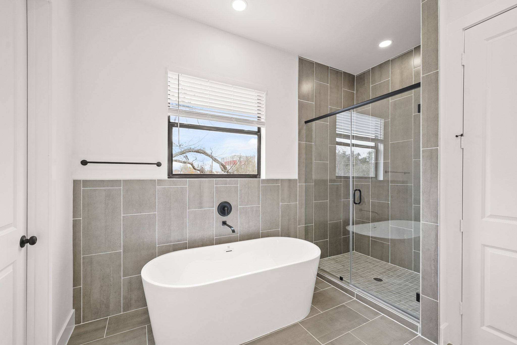 3419 Tuam Street Houston, TX 77004 - Photo 14 of 28 a white bath tub sitting next to a bathroom