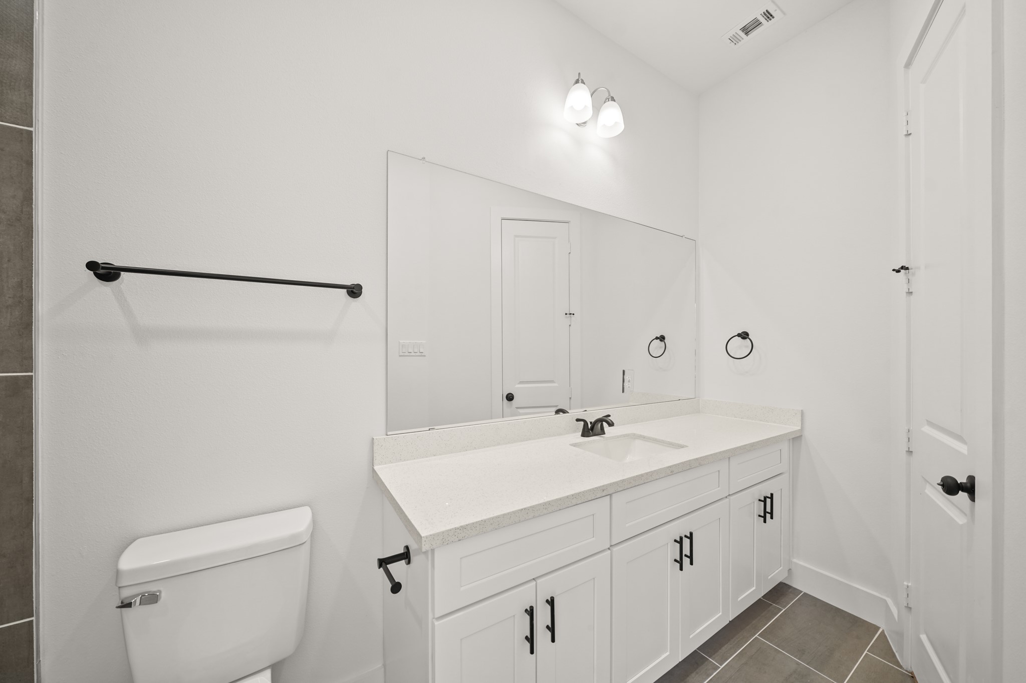 3419 Tuam Street Houston, TX 77004 - Photo 19 of 28 a view of bathroom with a sink a toilet and mirror