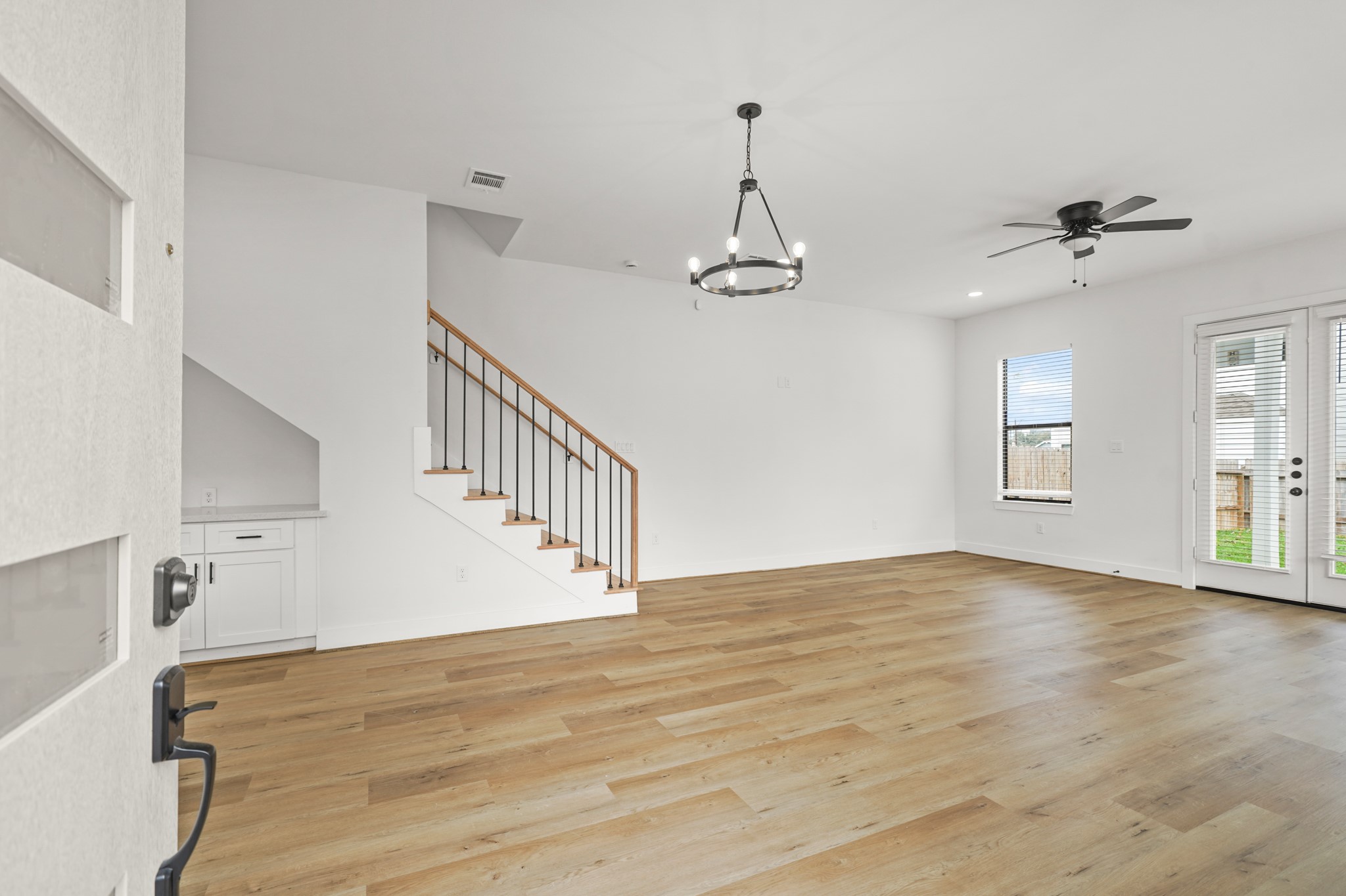 3419 Tuam Street Houston, TX 77004 - Photo 2 of 28 a view of an empty room with a window and wooden floor
