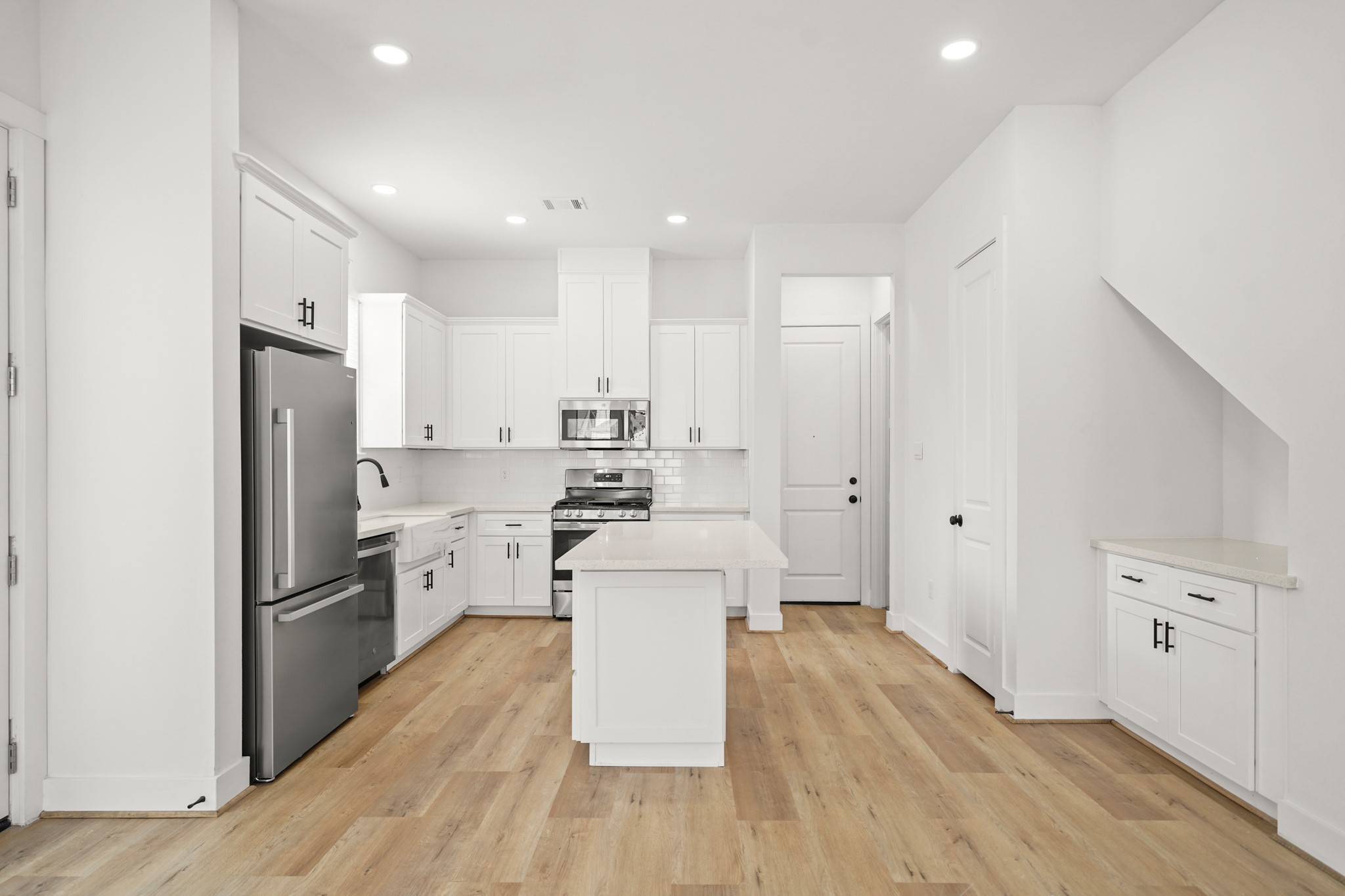 3419 Tuam Street Houston, TX 77004 - Photo 4 of 28 a kitchen with stainless steel appliances a refrigerator and a stove top oven