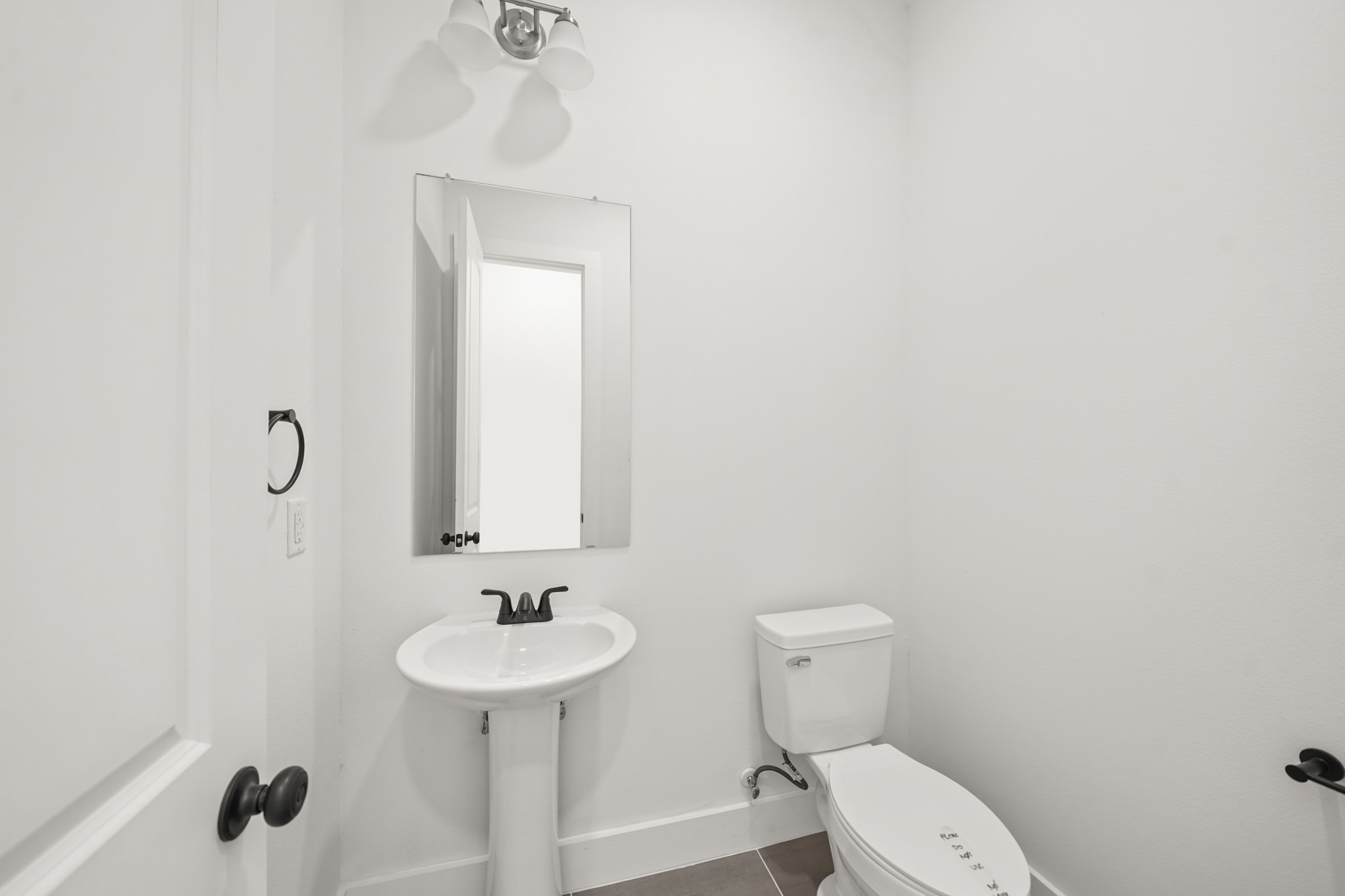 3419 Tuam Street Houston, TX 77004 - Photo 6 of 28 a bathroom with a sink a toilet and a mirror