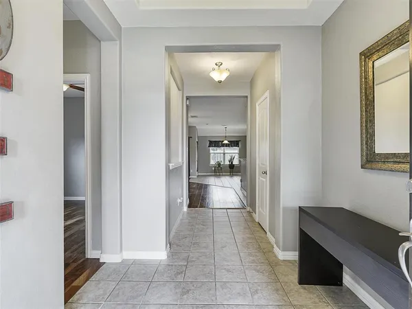 a view of a hallway and a livingroom with a glass door