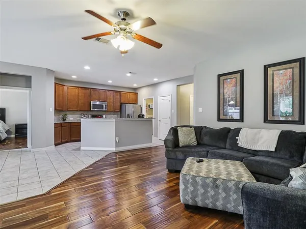 a living room with furniture and kitchen view
