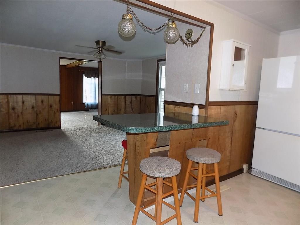 2303 Mercer Road Stoneboro, PA 16153 - Photo 7 of 22 a kitchen with a dining table and chairs