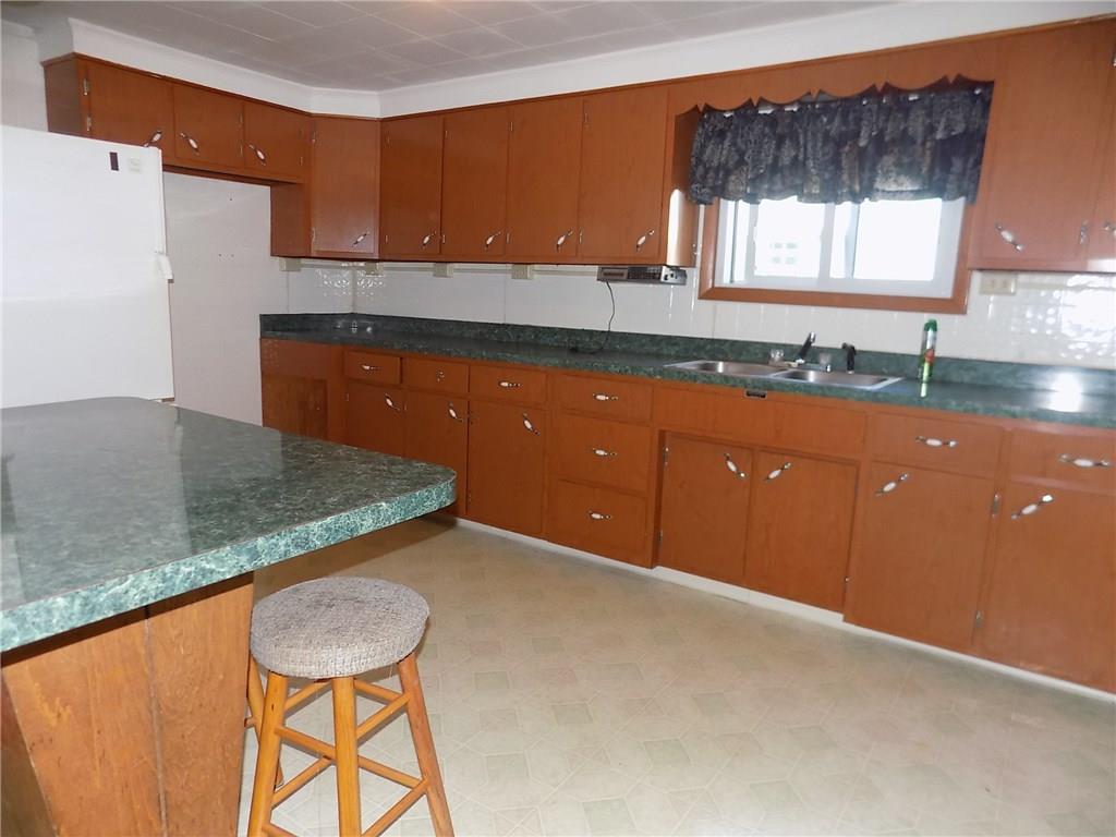 2303 Mercer Road Stoneboro, PA 16153 - Photo 9 of 22 a kitchen with a sink a window and cabinets