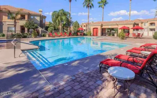 a view of a swimming pool with a lounge chairs