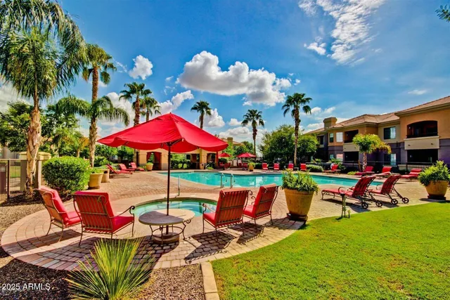 a view of a swimming pool with sitting area